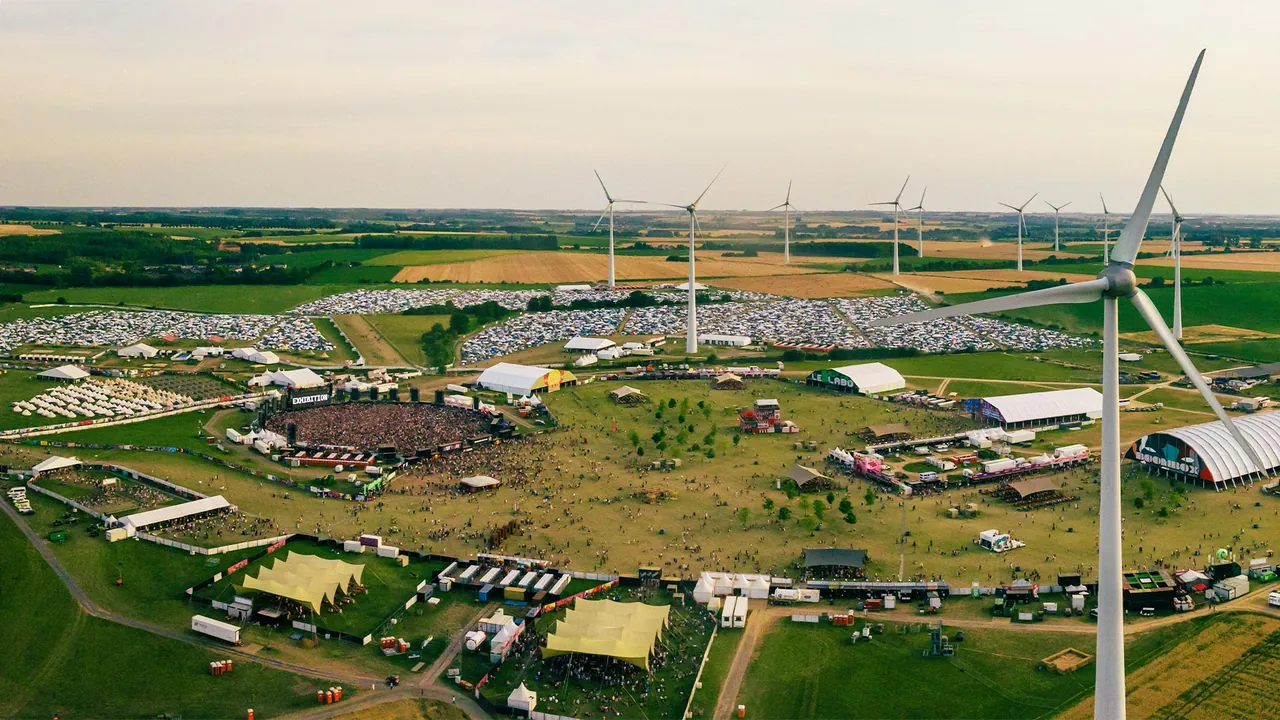 Drone view of the Dour Festival site: campsites, stages and wind turbines among the fields of Hainaut.