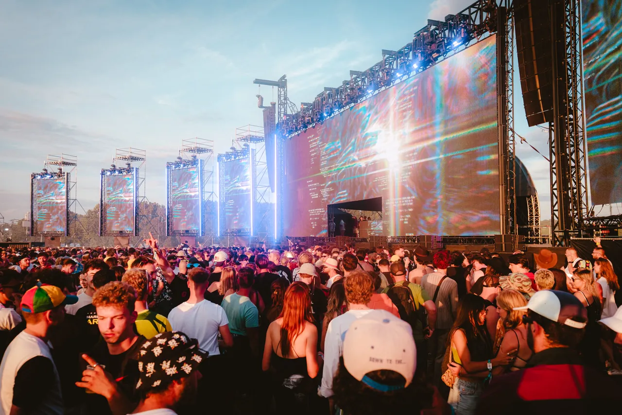 The crowd in front of a wall of LED screens late in the day, 2025 edition.