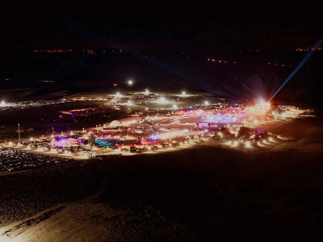 The site lit up at night in the middle of the desert, seen from above.