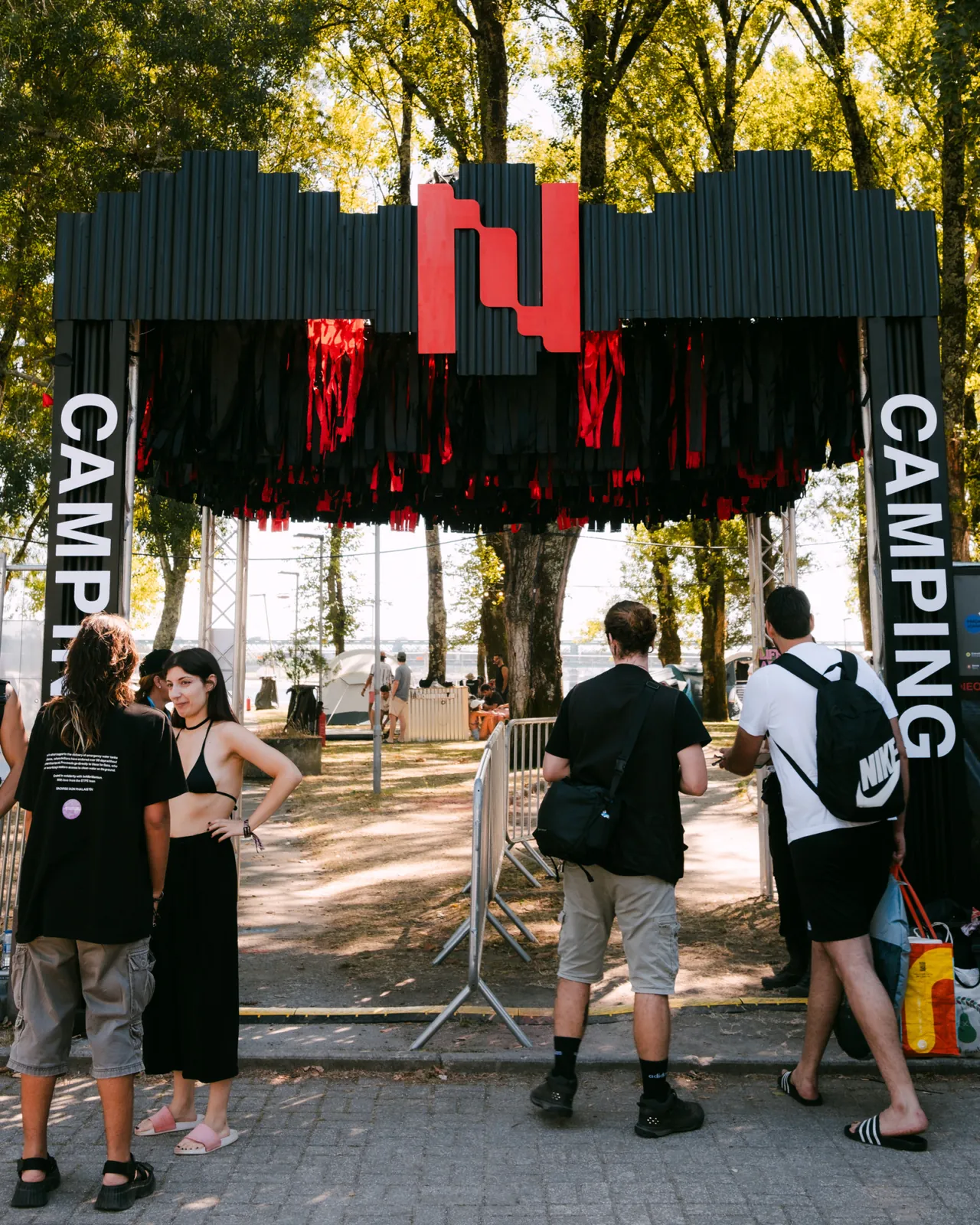 The NeoCamping entrance under the trees, 2026 edition.
