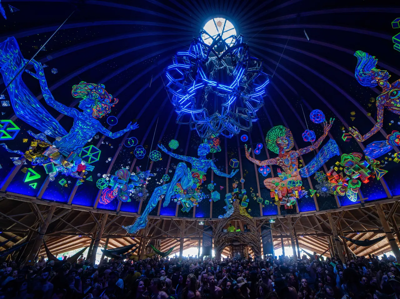 The vault of the Dome, a timber frame and fluorescent murals around the central lantern, in 2023.