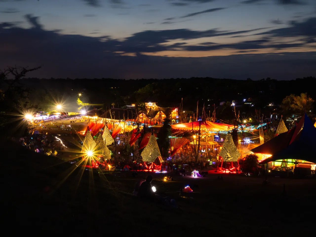 The Dádpuszta valley at nightfall, with stages and tents lit up, in 2023.