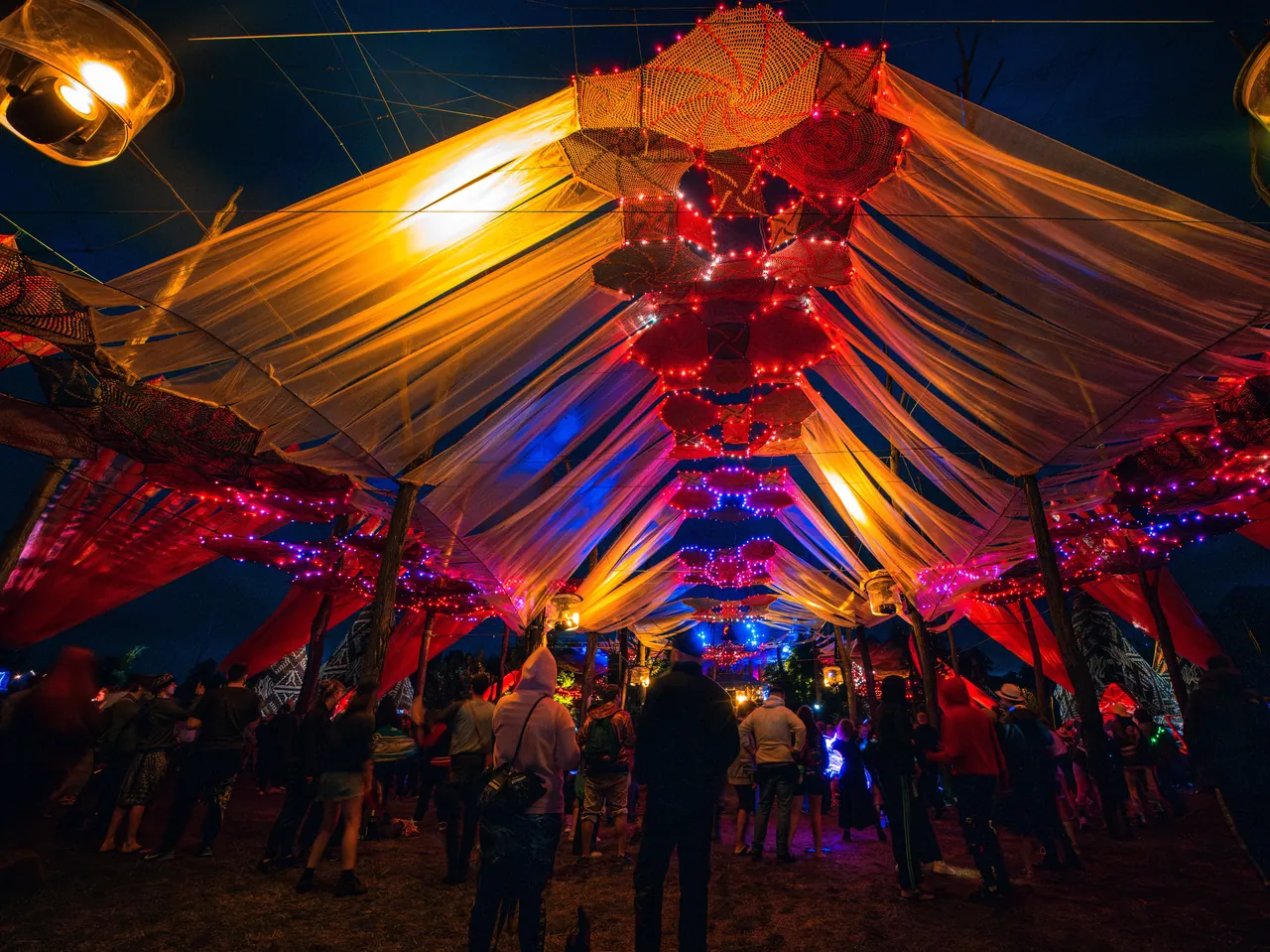 Under the stretched canopy of one of the festival's covered stages, at night, in 2023.