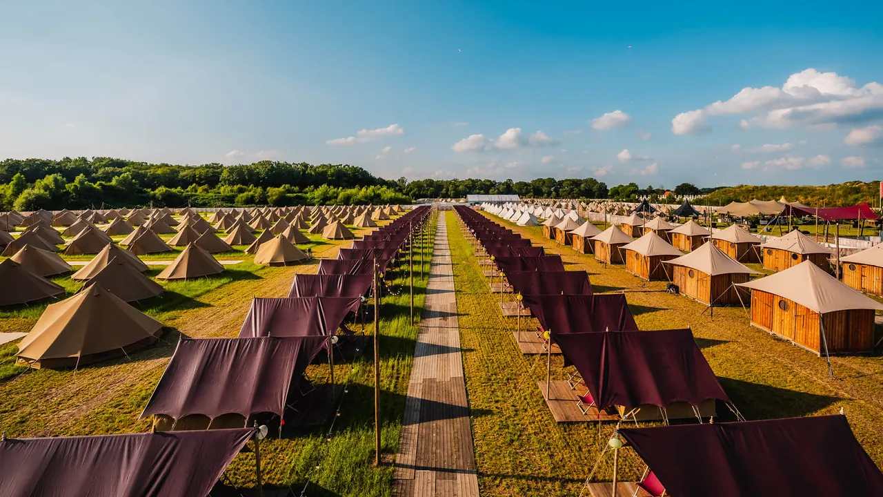 The ready-pitched tents and cabins of the Deluxe Village in the Glamping District.