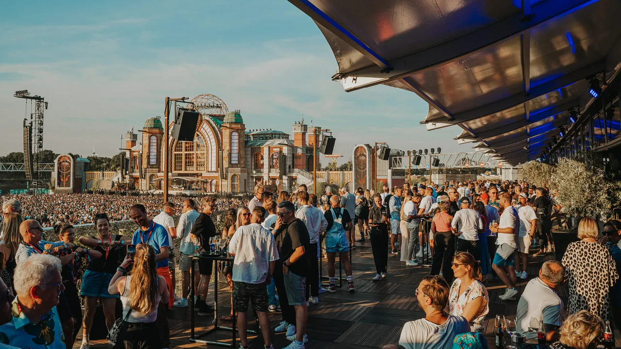 The Platinum Club terrace facing the Mainstage and the Arena crowd in the late afternoon.