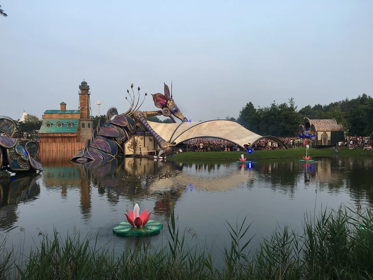 A Tomorrowland 2016 stage on the lake at De Schorre, decorated with a giant dragonfly and glowing water lilies, on 23 July 2016